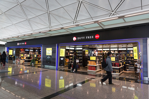 Hong Kong, Hong Kong SAR - January 26, 2015: People walk past the Duty Free Shop in Hong Kong International Airport. 