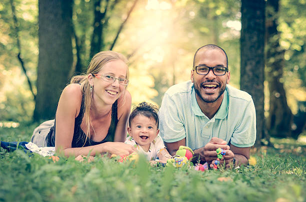 счастливая семья interracial - adoption family multi ethnic group human teeth стоковые фото и изображения