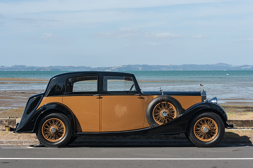 Auckland, New Zealand - March 2, 2013: vintage rolls-royce parked at beach in Auckland, New Zealand