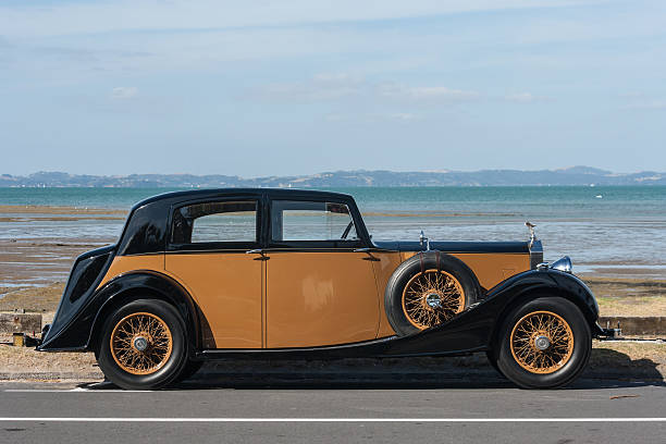 vintage rolls-royce Auckland, New Zealand - March 2, 2013: vintage rolls-royce parked at beach in Auckland, New Zealand rolls royce stock pictures, royalty-free photos & images