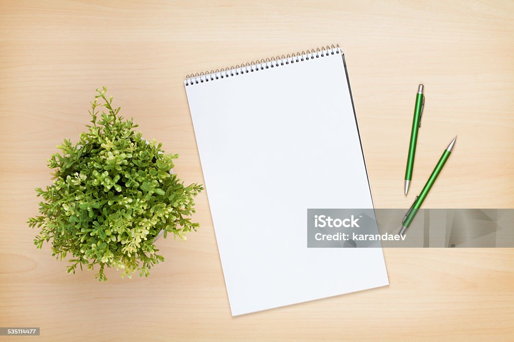 Blank notepad, pen and flower on wooden table Blank notepad, pen and flower on wooden table. View from above 2015 Stock Photo