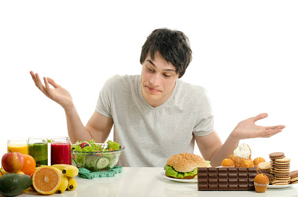 istock Man choosing between fruits, smoothie,salad and sweets 535114679