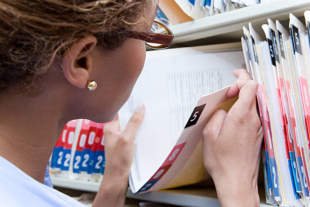 Administrator looking at medical record stock photo