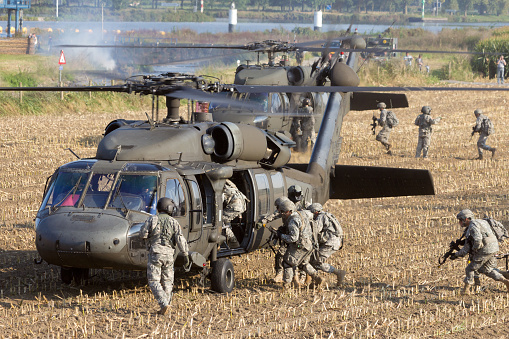 Grave, The Netherlands - September 17, 2014: Soldiers of the 82nd Airborne Division enter a Black Hawk helicopters at the Operation Market Garden memorial on Sep 17, 2014 Grave, Netherlands. Market Garden was a large Allied operation in 1944.