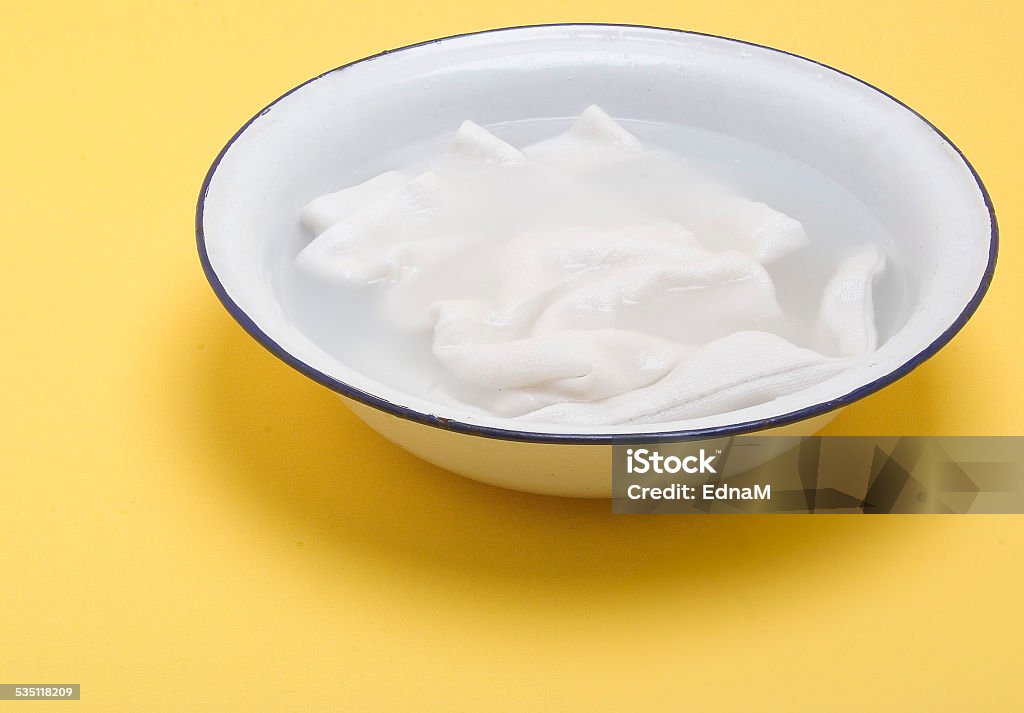 Laundry for bleaching in an enamel bowl 2015 Stock Photo