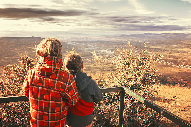 istock Kids on high ground looking at city 535161501