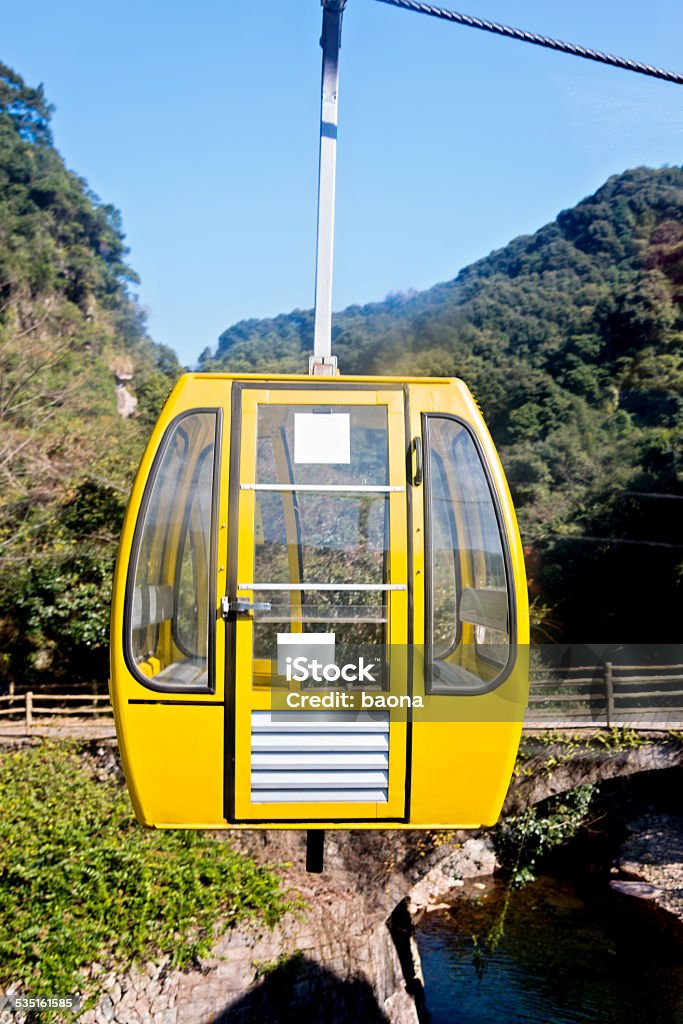 yellow cable car Group of cable cars approaching the top of mountain in China. 2015 Stock Photo