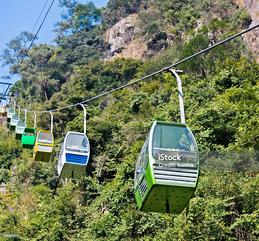 cable cars Group of cable cars approaching the top of mountain in China. 2015 Stock Photo