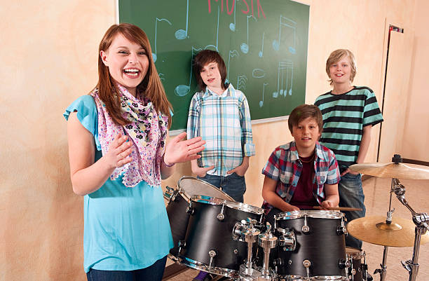 istock Students at music class girl clapping smiling  boy playing drums 535162115