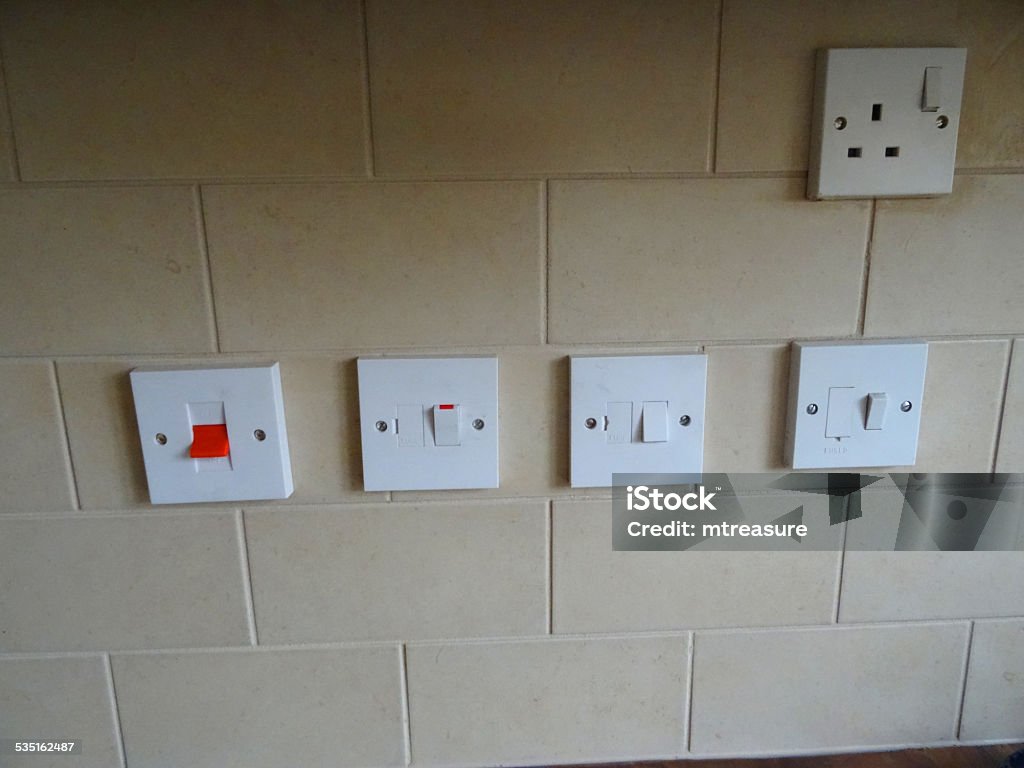 Cooker / kitchen switches, plug-socket, brick tiling, beige / brown wall tiles Photo showing a row of red and white cooker / kitchen switches and a single plug-socket. The switches and plug socket are pictured against brick tiling - with small beige / brown wall tiles. 2015 Stock Photo Cooker / kitchen switches, plug-socket, brick tiling, beige / brown wall tiles Photo showing a row of red and white cooker / kitchen switches and a single plug-socket. The switches and plug socket are pictured against brick tiling - with small beige / brown wall tiles. 2015 Stock Photo