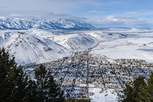 Jackson Wyoming and Teton Valley - View looking down into town and off toward Yellowstone.  Grand Teton and mountains.  Jackson, Wyoming, USA.