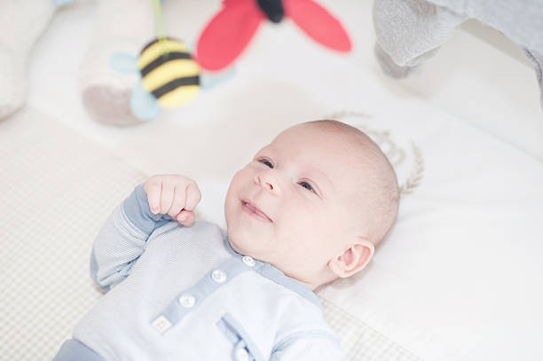 istock Charming baby playing with a toy lying on back 535165049