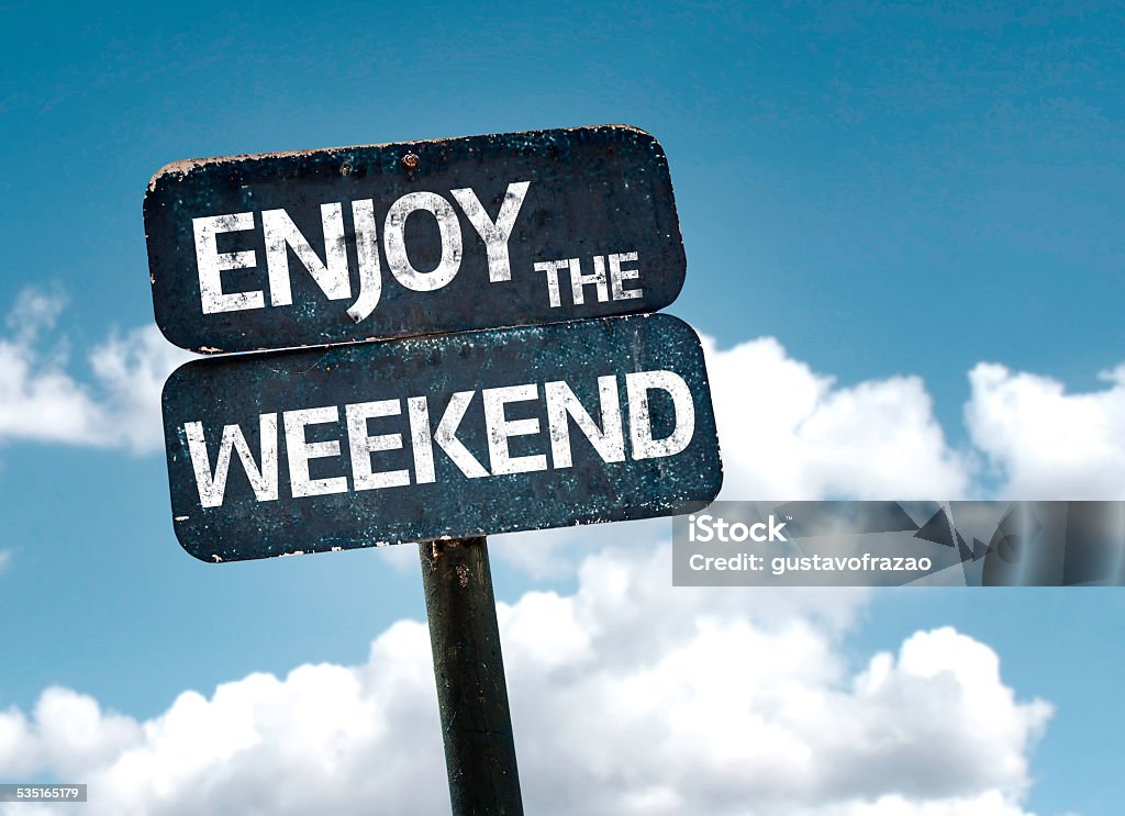 Enjoy the Weekend sign with clouds and sky background Weekend Activities Stock Photo