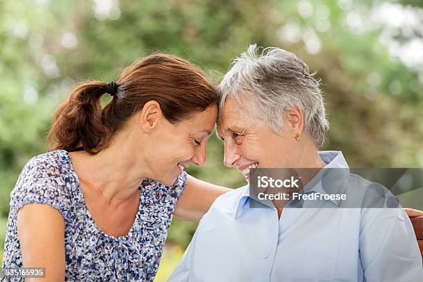 Senior Woman And Caregiver Outdoors In A Garden Stock Photo - Download Image Now - Community Outreach, Senior Adult, Family