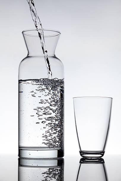 istock Empty glass and a carafe filled with water 535166813