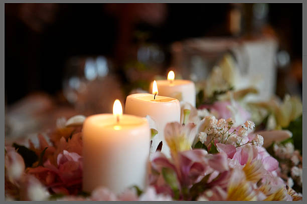 Lighted candles and flowers in a wedding centerpiece