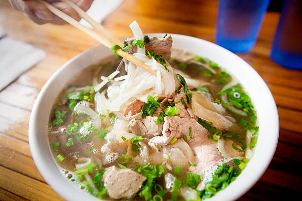 Vietnamese Pho Noodle Soup Dish Vietnamese Pho Noodle Soup with variety of meat and vegetables. vietnamese culture photos stock pictures, royalty-free photos & images