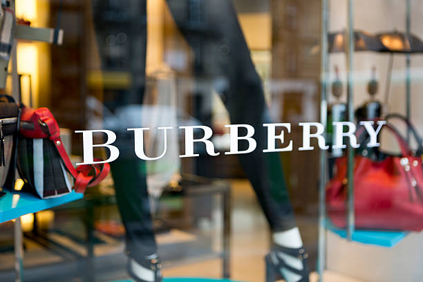 Burberry window display in Paris, France Paris, France - January 24, 2015: A window display features contemporary fashions at a Burberry store in Paris.  Burberry is a globally recognized retailer of premium clothing and accessories. designer clothing photos stock pictures, royalty-free photos & images