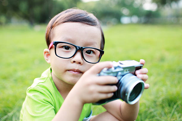 istock cute child plays the photographer 535170039