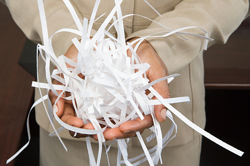 Woman holding shredded paper