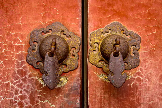 Close-Up of doorhandles and cracked lacquer on a door in a chinese temple