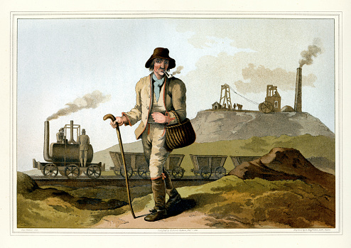 Vintage colour engraving of a Yorkshire Coal Miner (Collier). This the background is an steam engine invented by Mr Blenkinsop, agent at the colliery of Charles Brandling, near Leeds, which conveys twenty waggons loaded with coal from the pits to Leeds. Yorkshire, England. The Costume of Yorkshire by George Walker. 1815