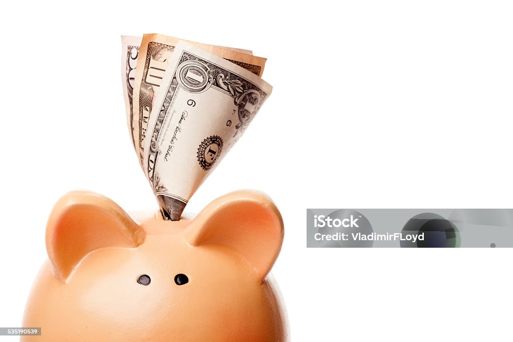 Close up of piggy bank and money put into it close up of piggy bank and money put into it 2015 Stock Photo