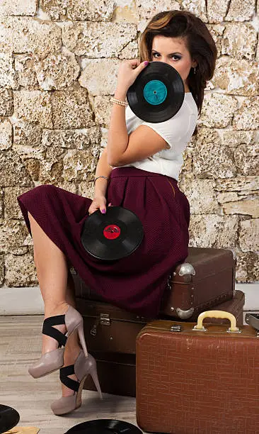 Photo of Beautiful girl with vintage vinyl records