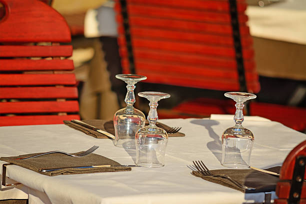 istock restaurant table with glasses, forks and napkins 535193339