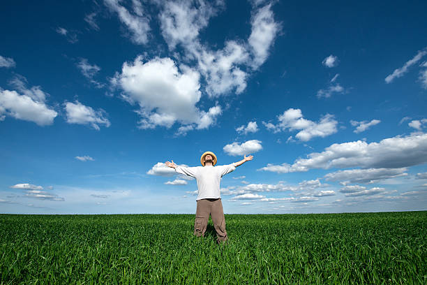 young man on green field of wheat