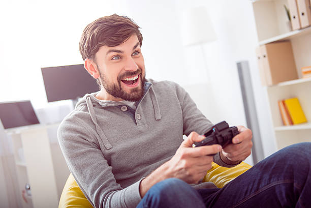 istock Man playing videogames and holding joystick 535194418