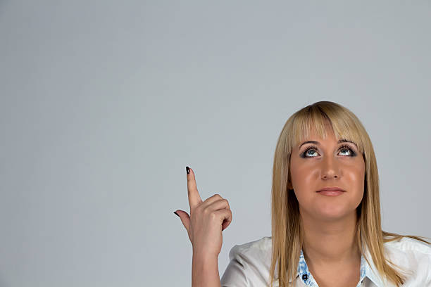 istock Image of woman showing and looking up 535196215
