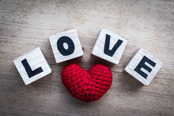 istock Alphabet Blocks ( love ) and Red Heart Shaped Silk 535196681