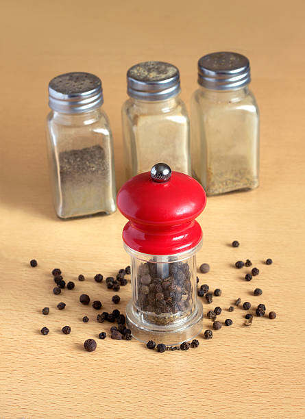 istock Pepper, pepper mill and spice jars on kitchen desk closeup 535196707