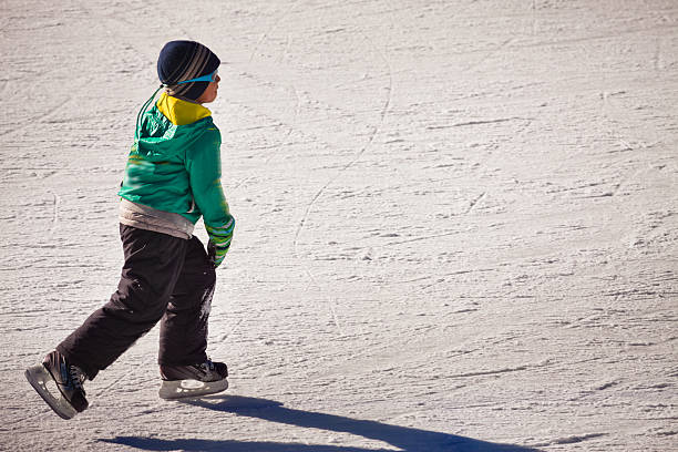 little boy in winter clothes on ice rink at Kazakhstan, Almaty