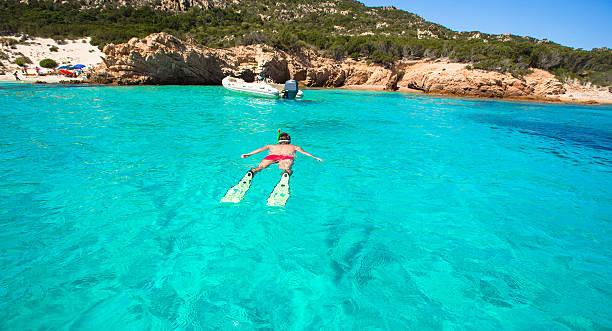 istock Young man snorkeling in clear tropical turquoise waters 535197275