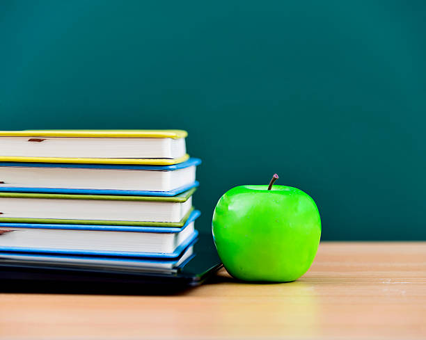 istock apple on top of books and laptop 535198207