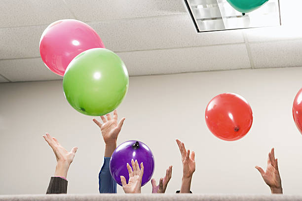 Office workers playing with balloons Office workers playing with balloons office parties stock pictures, royalty-free photos & images