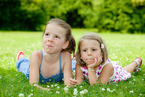 Three young  girls posing outdoors.