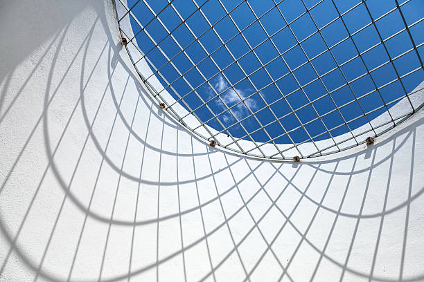 istock Blue sky behind round window with metal grid 535199431