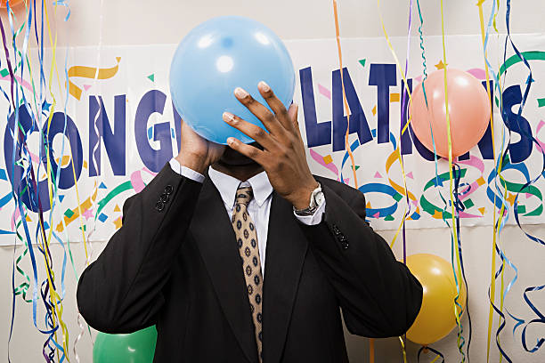 istock Businessman blowing up a balloon 535199619