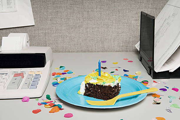 Birthday cake on an office desk Birthday cake on an office desk office party stock pictures, royalty-free photos & images