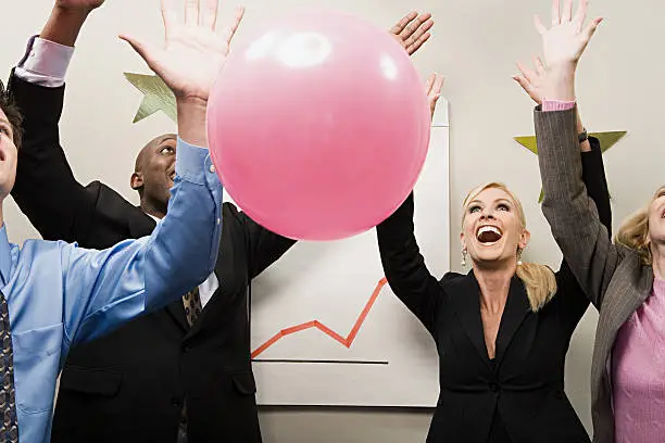 Photo of Four office workers celebrating