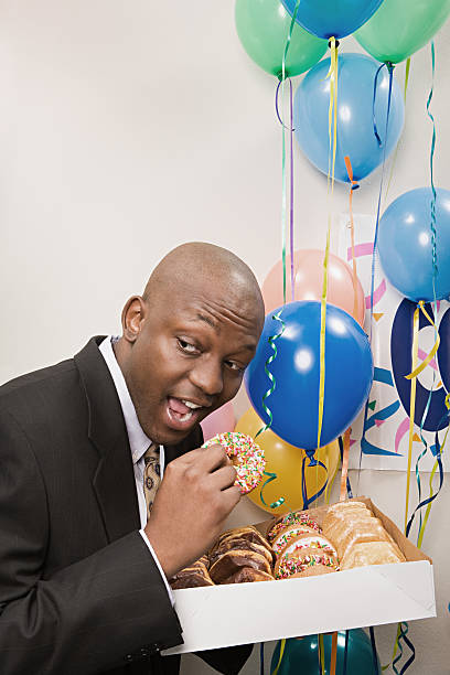istock Businessman secretly eating doughnuts 535199671