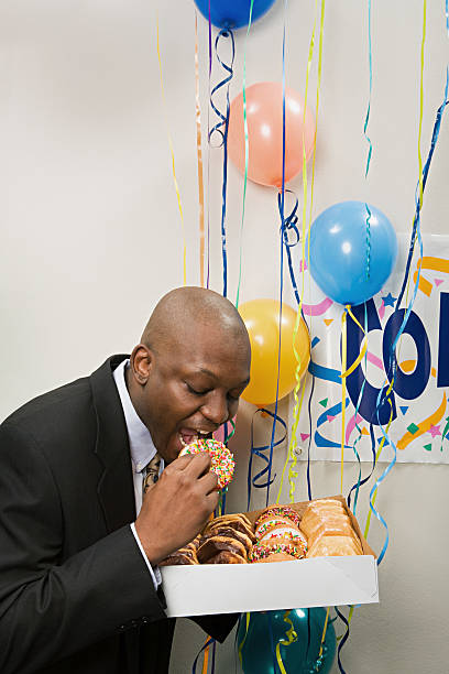 istock Businessman secretly eating doughnuts 535200919
