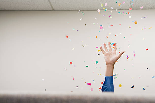Businessman throwing confetti in the air stock photo