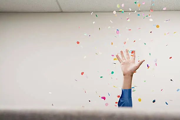 Photo of Businessman throwing confetti in the air