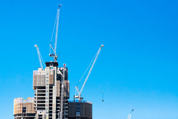 istock Construction of skyscrapers with tower cranes with copy space 535201137