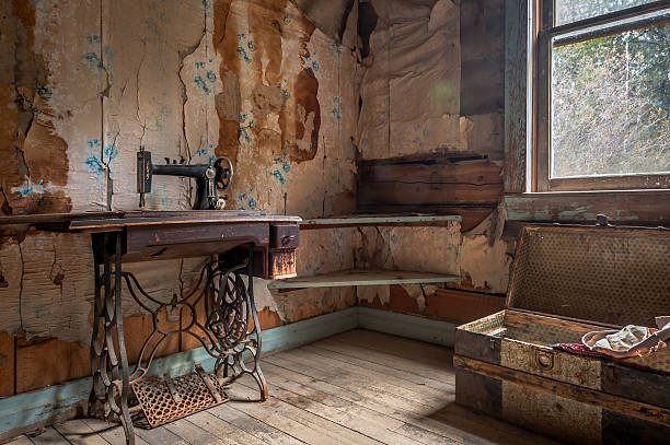 Stained Old Treadle Machine and chest in an abandoned hotel in Garnet, Montana ghost town stock pictures, royalty-free photos & images