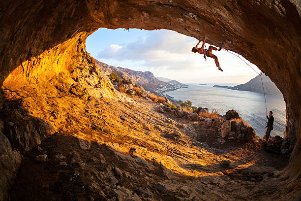 istock Young woman lead climbing in cave 535219311